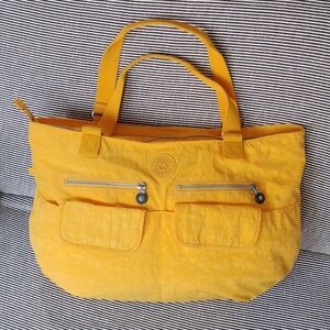 Kipling yellow nylon weekend bag.